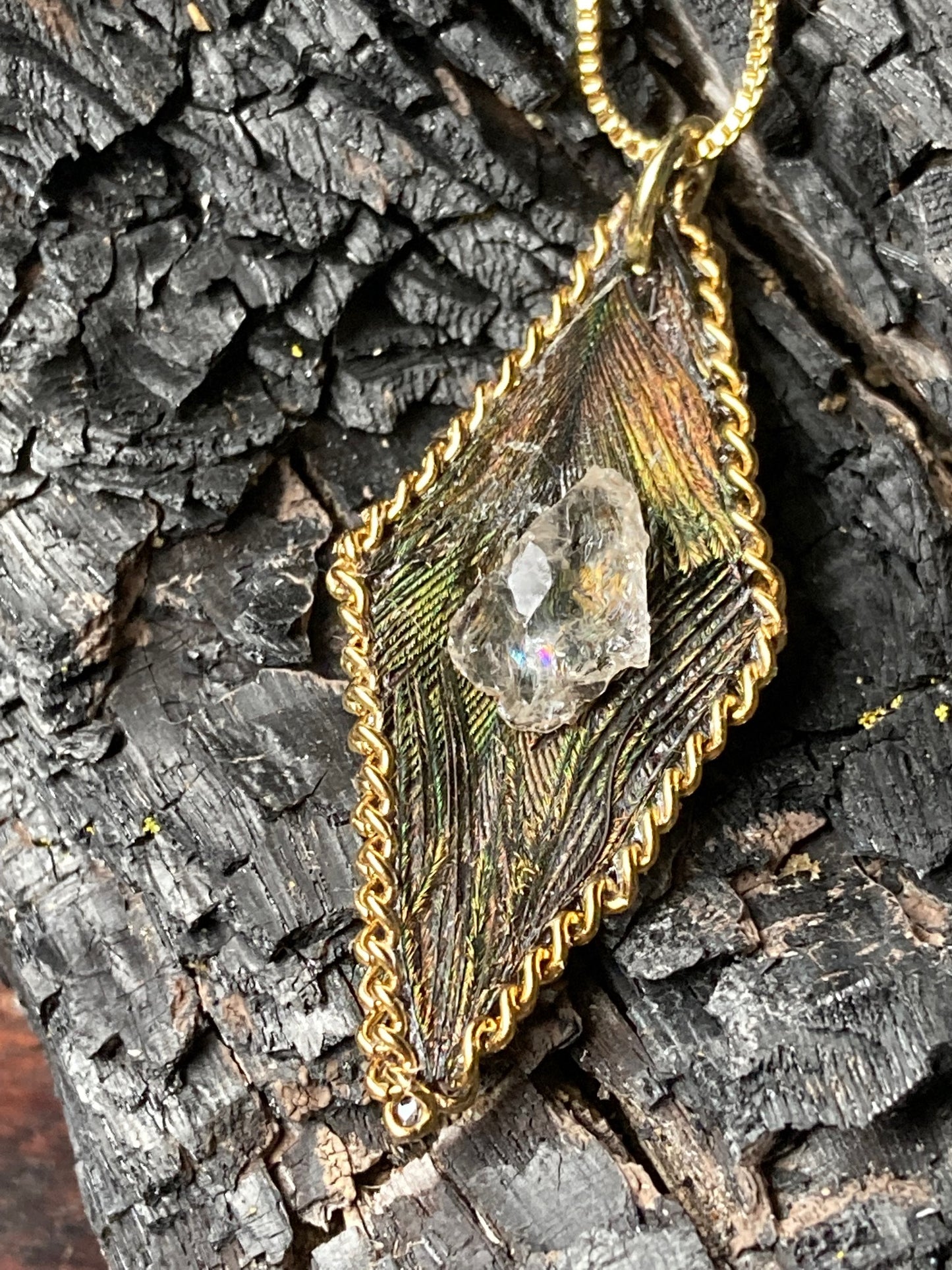 Diamond shaped feathered pendant adorned w/ a Northern California diamond