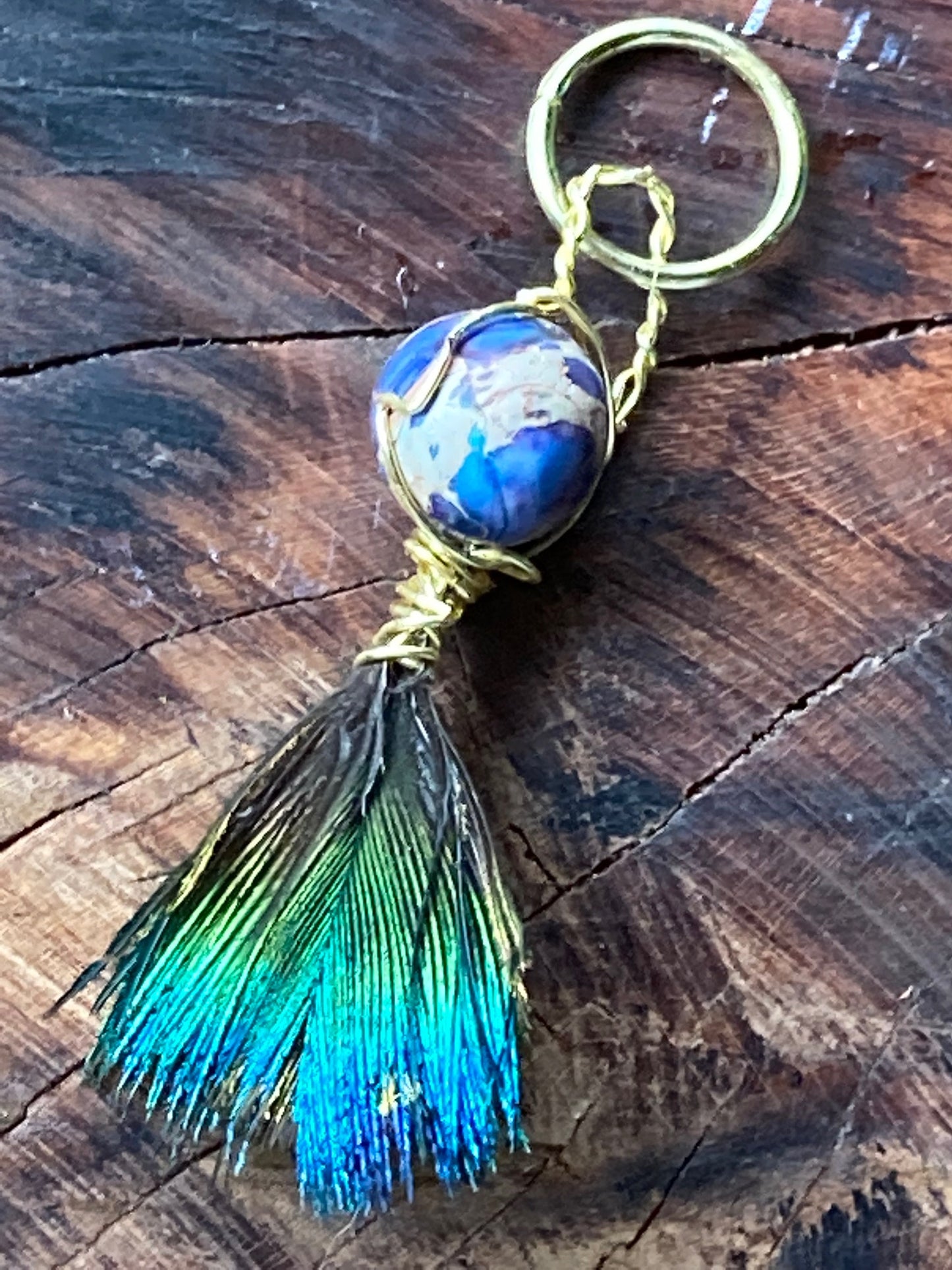 Charm with double sided feather and bead