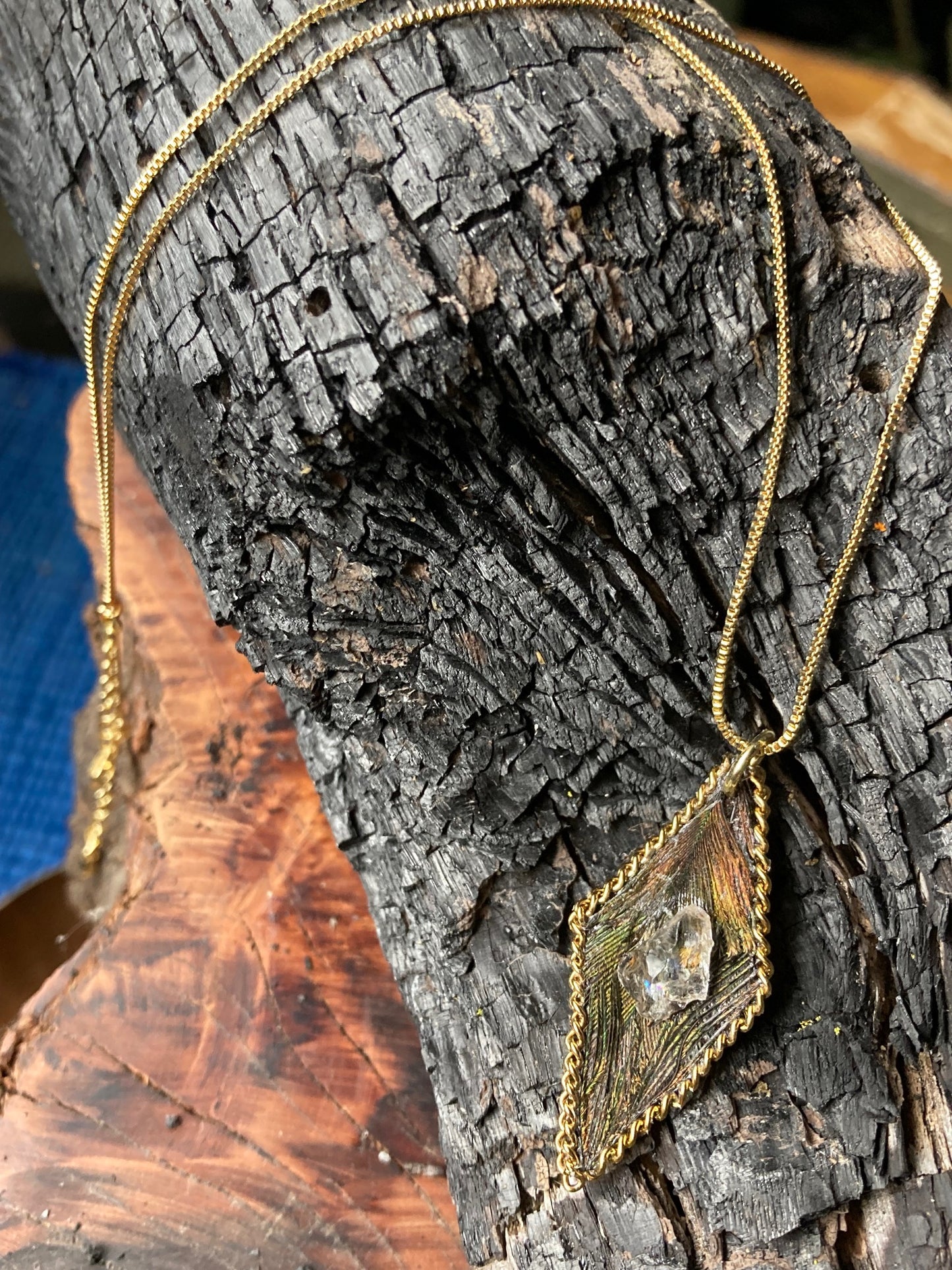 Diamond shaped feathered pendant adorned w/ a Northern California diamond