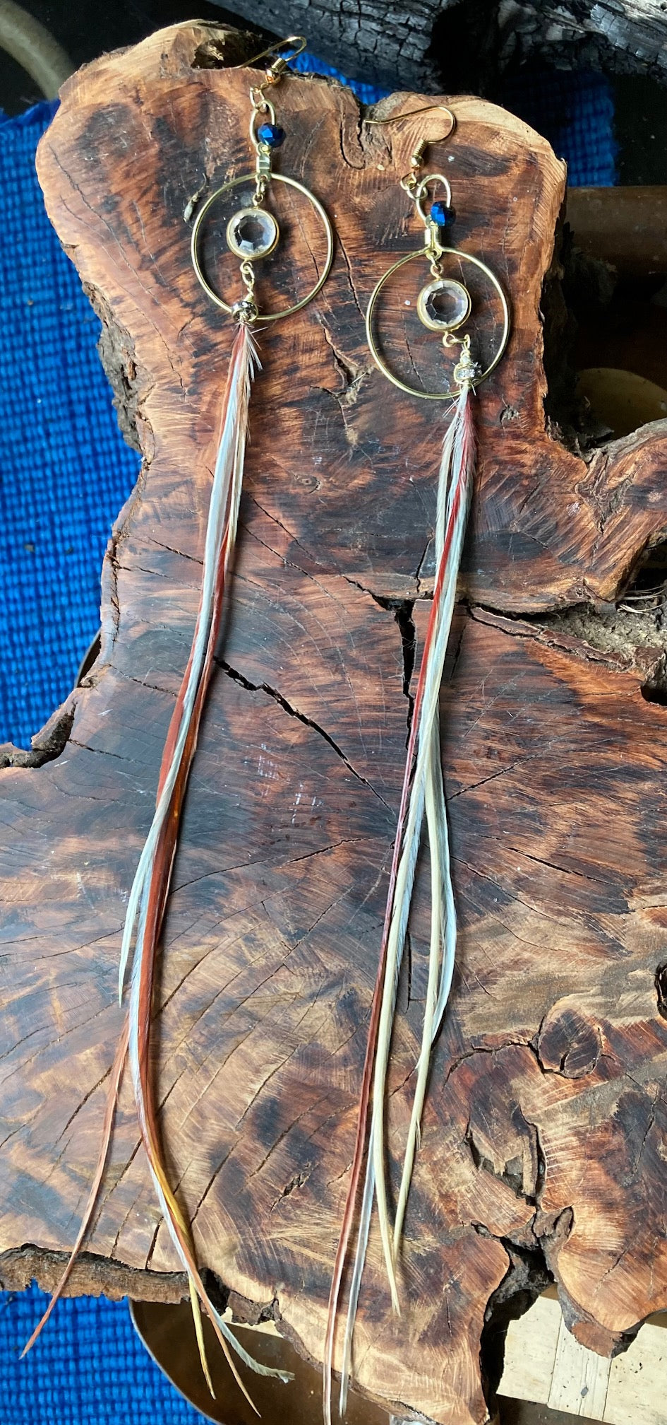 Gold circle crystal center with long dangling thin feathers, earrings