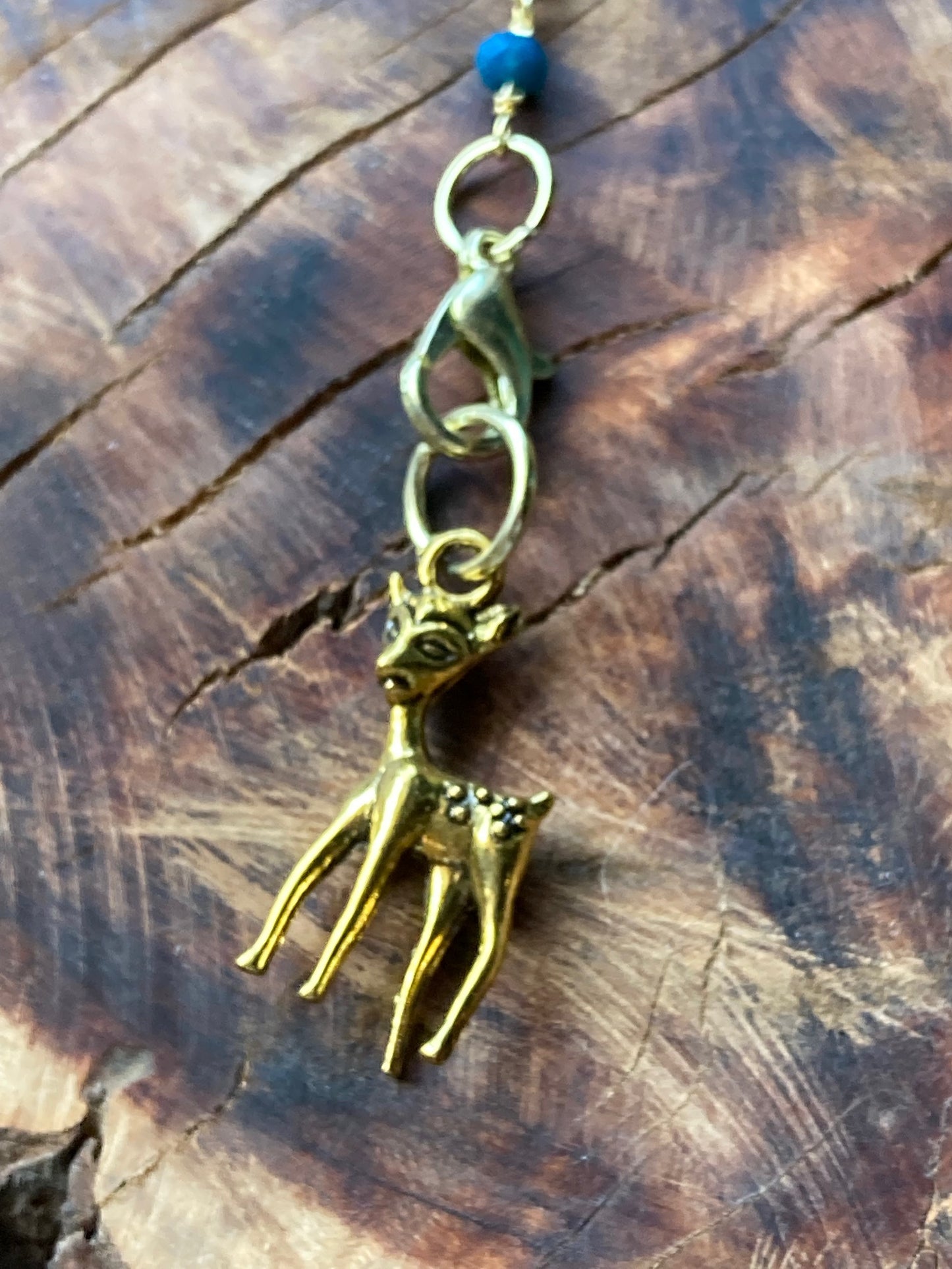 Hair charm dangle made of tanzanite beads with gold deer charm